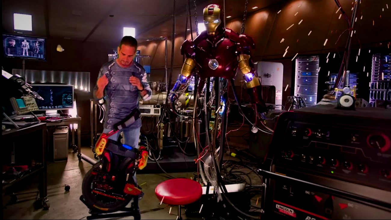 Rick Lewis on the Iron Lynx build next to a full Iron Man suit.
