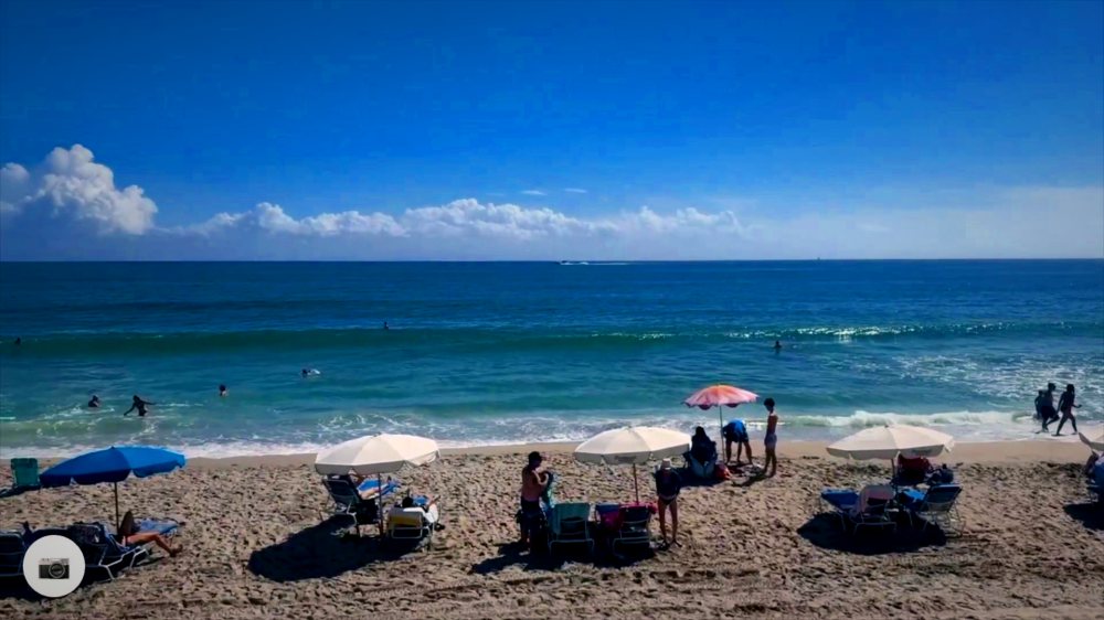 Riders and boards parked on the sand at the end of a beach run.