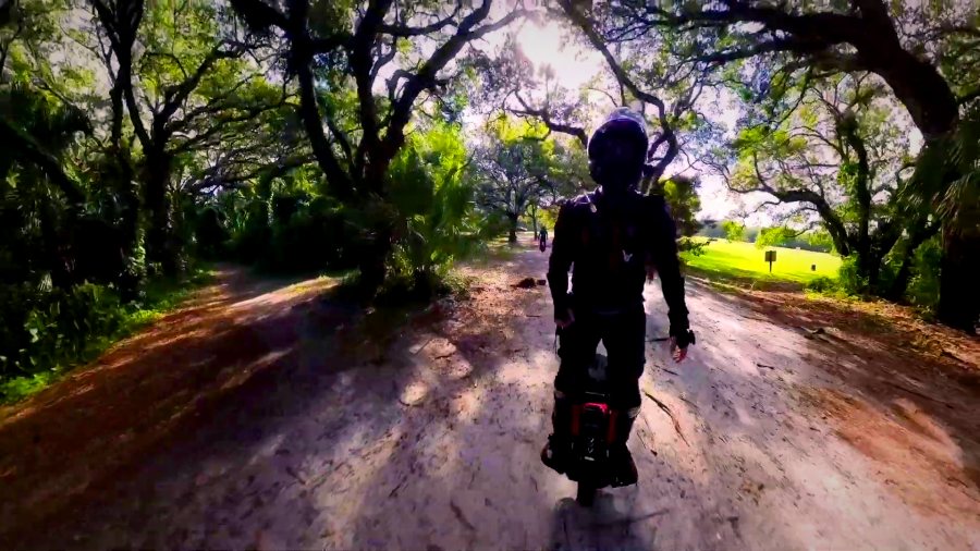A rider on a dirt trail under a canopy of oaks on the 4 Park Run.