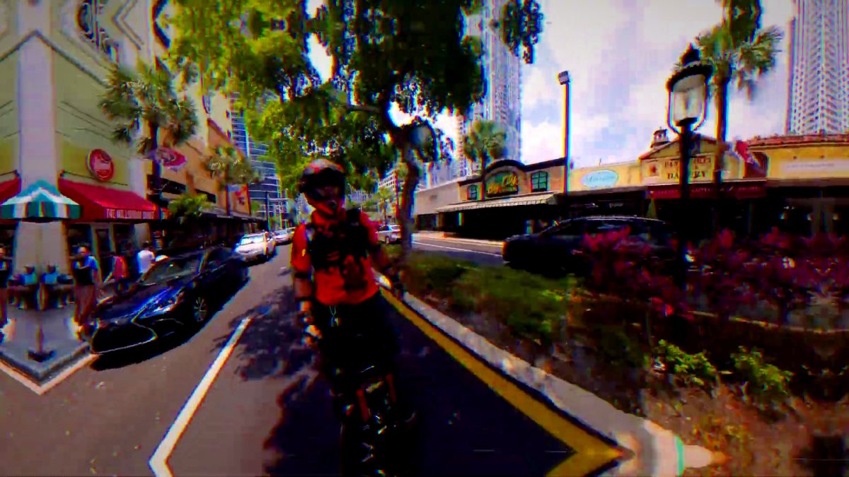 A rider in armor on a downtown street.